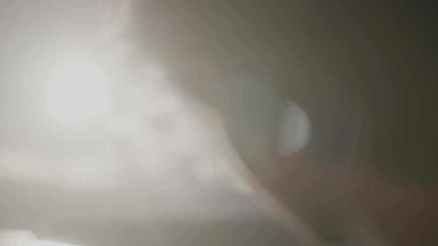 Close-up of a man turning his head towards the sunset