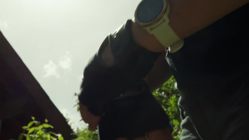 A man tightens the straps on his gloves