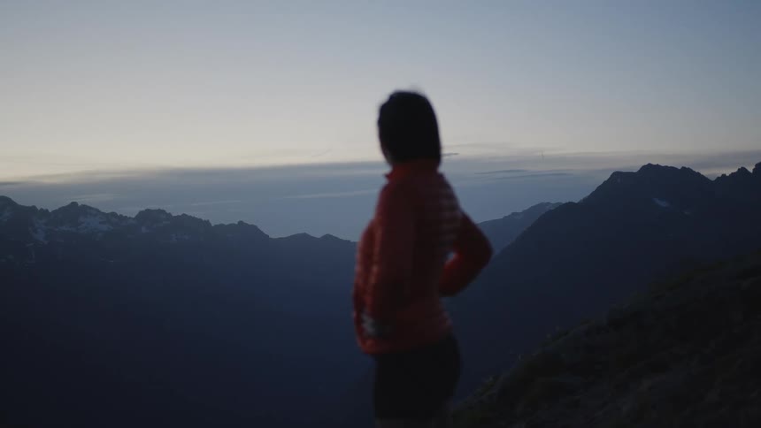 A woman takes in the view at the top of a canyon