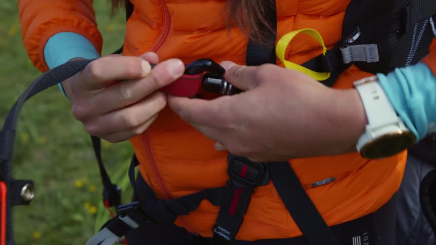 A woman is getting ready to paraglide