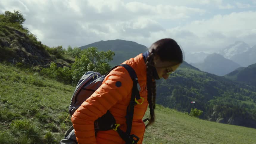 A young white woman is getting prepared to go paragliding