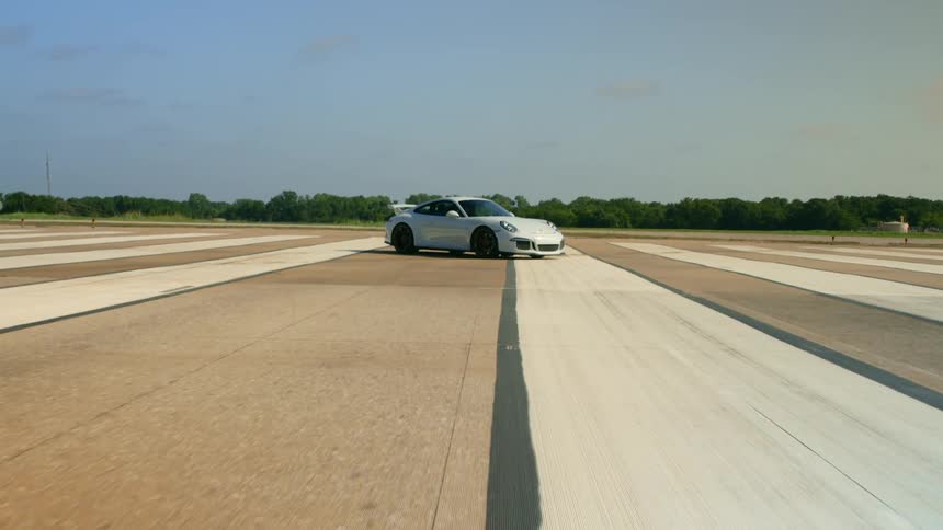 A sports car parked on a runway on clear day