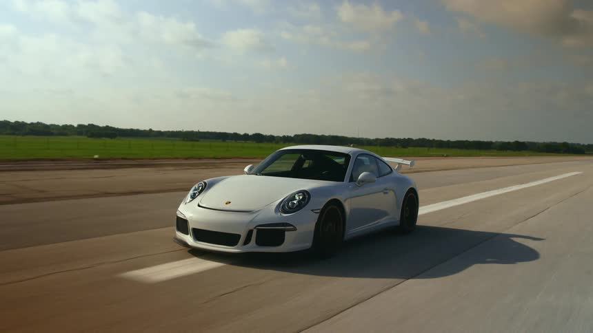 A sports car driving on an open road