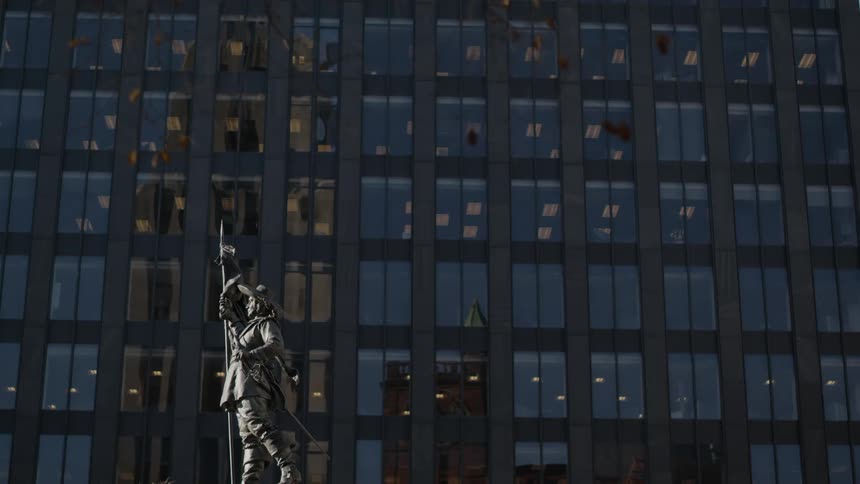 A statue in front of an office building