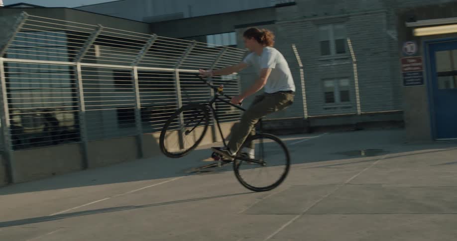 A man is riding a bike and doing tricks