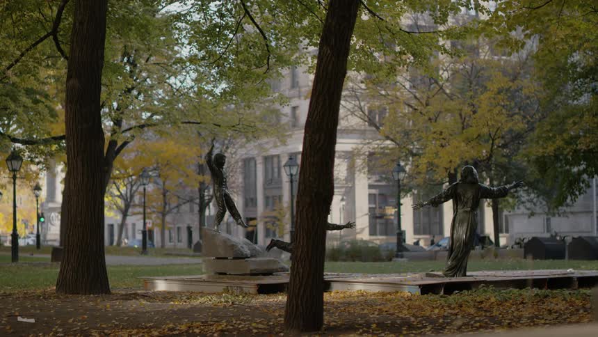 A city park with the sculpture hommage marguerite bourgeoys in montreal
