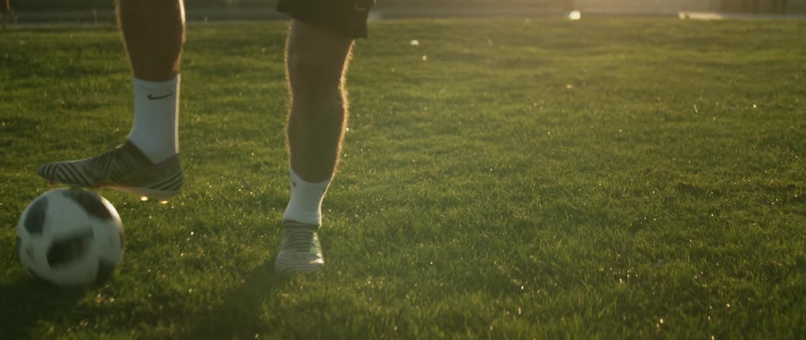A male running and kicking a soccer ball