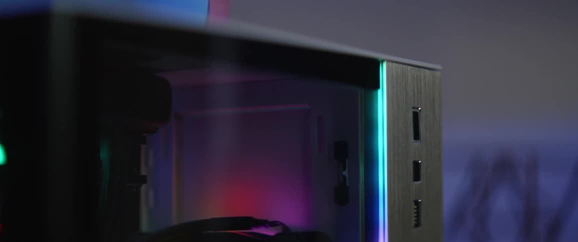 A person presses the power button on a gaming computer