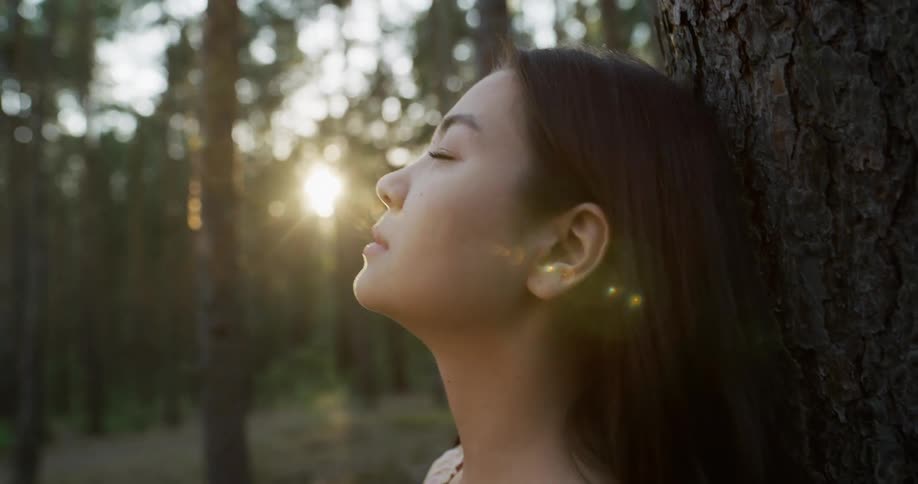 A female in the woods meditating