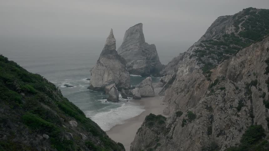 Very tall and pointy rock formations on a beach