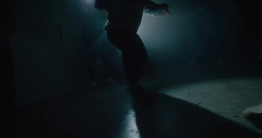 A group of men break dance in a semi circle
