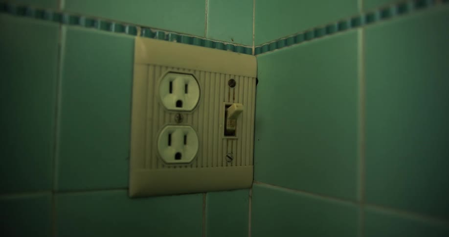 A person turning on a light switch