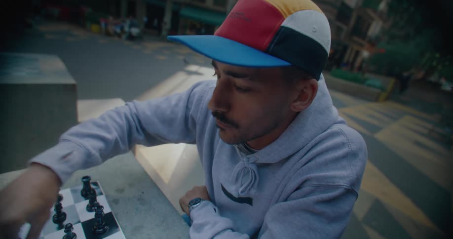 A man is playing chess in the park