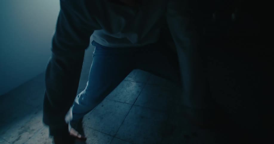 A man is dancing under the spotlight