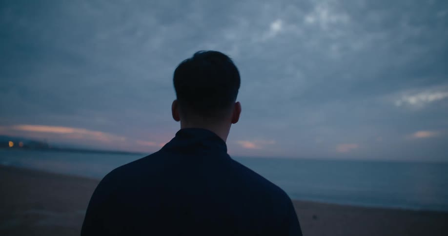A man is walking on the beach