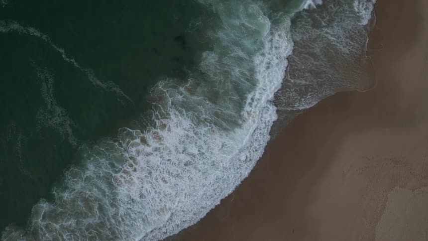Waves wash up on a sandy beach