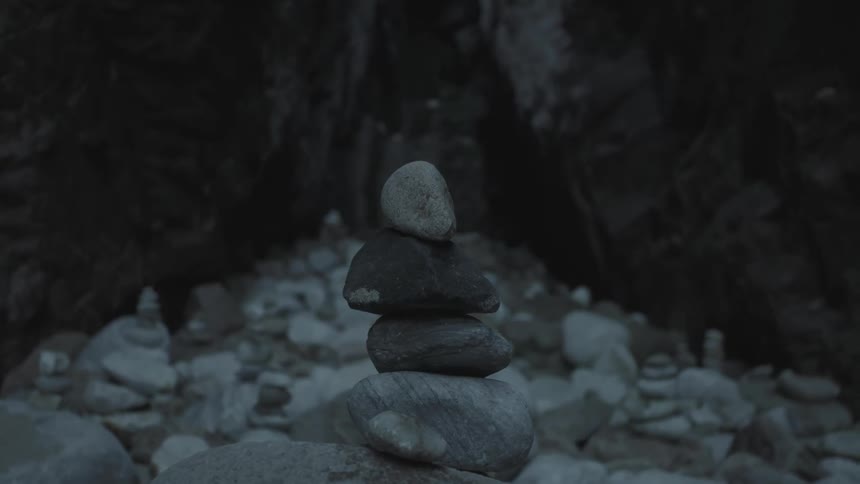 Several small rocks stacked atop each other in a very rocky area