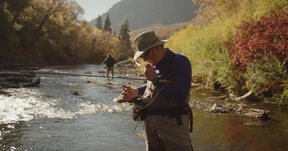 Men are fishing from a river in the mountains