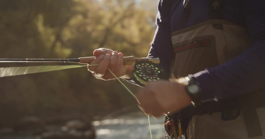 A man is fly fishing in the river