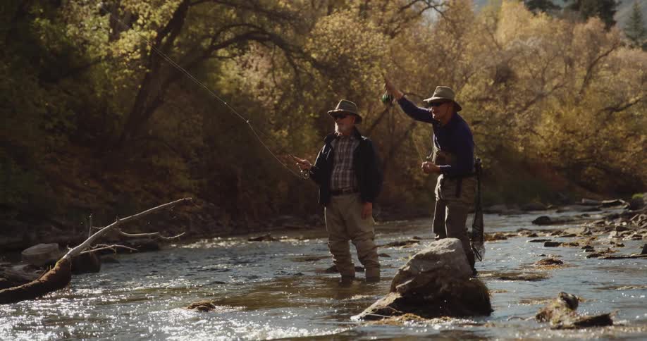 Two men are fly fishing in the river