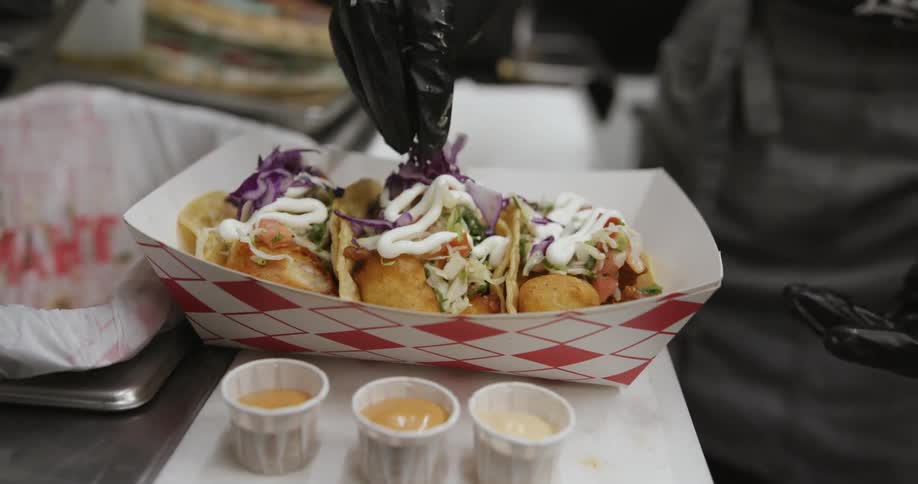 A chef is making tacos in the food truck