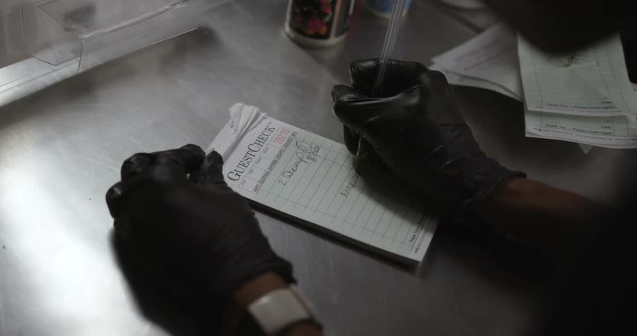 A person is writing up a receipt