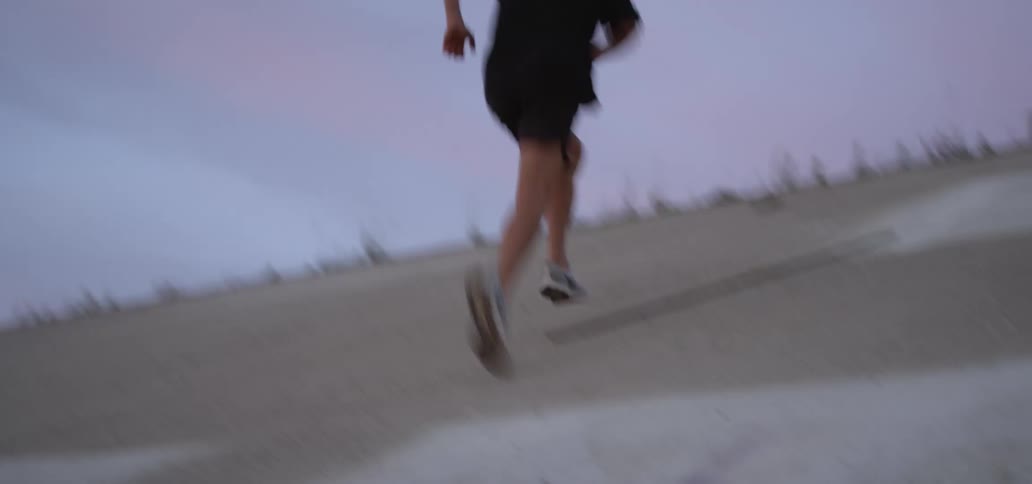 A man sprints up the sloped cement walls of an aqueduct
