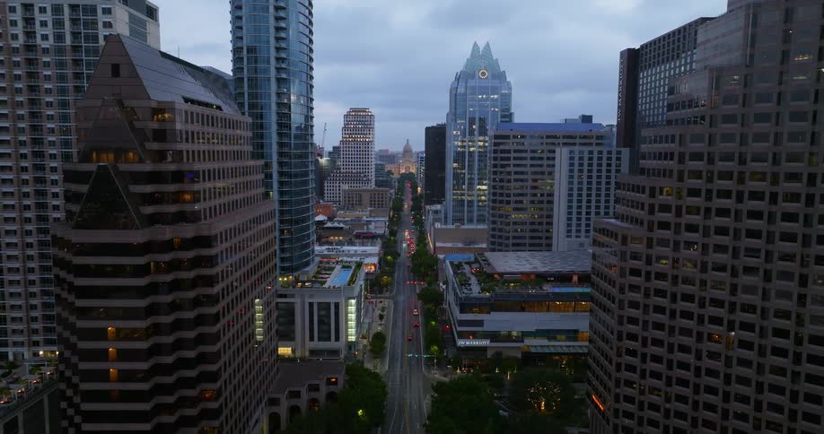 Aerial view of high rise office buildings and highway on cloudy day in the city