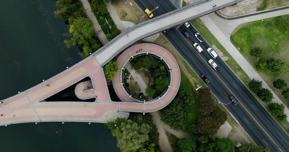 A large walking bridge over a roadway during the day
