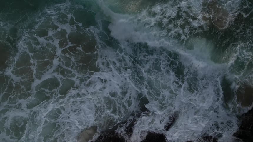 Overhead view of waves crashing ashore