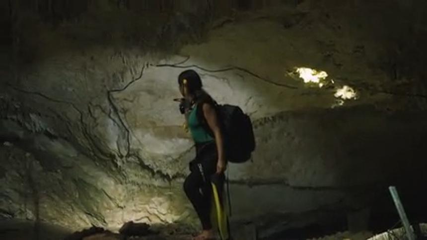 A woman walking around in a cave