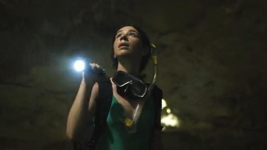 A woman explores a cave by herself