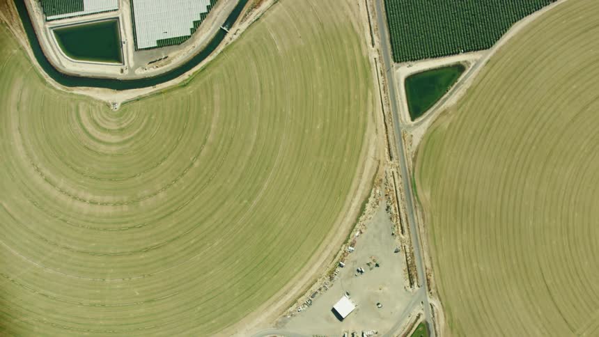 An irrigation canal weaves through arid farmland in this looking straight down aerial