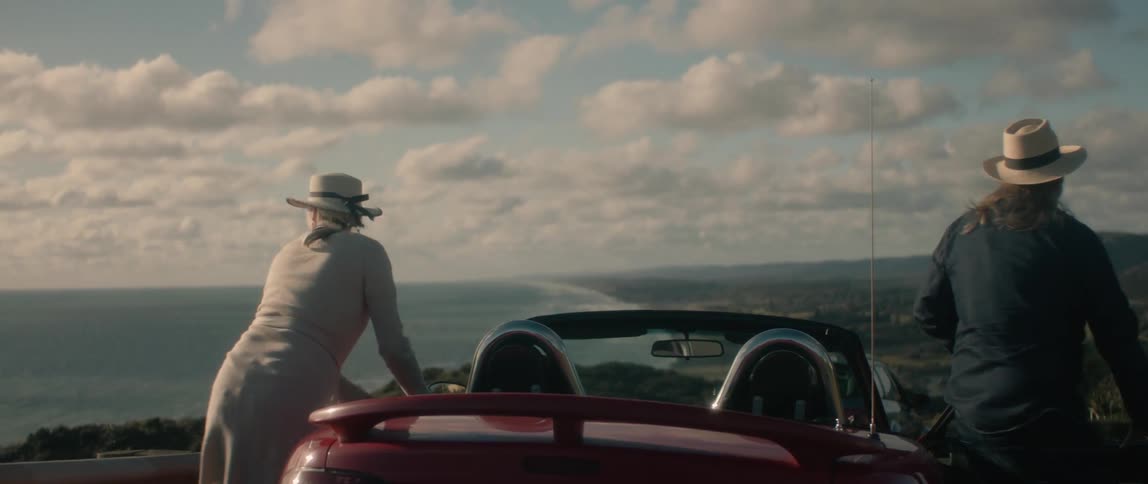 A man and woman getting out of a car