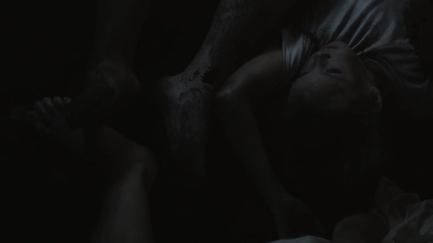 A person is laying down in the dark