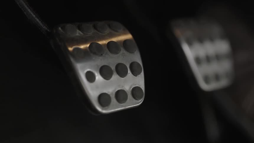 Feet using a car's pedals