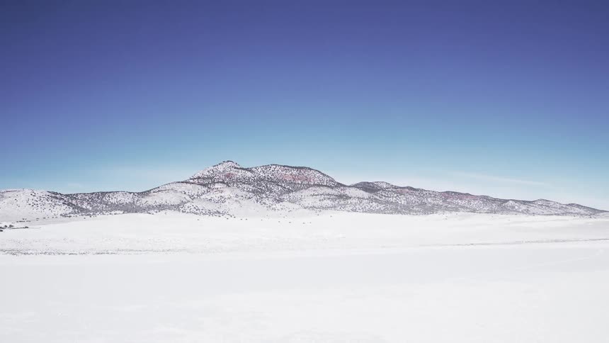 A long field is covered with snow