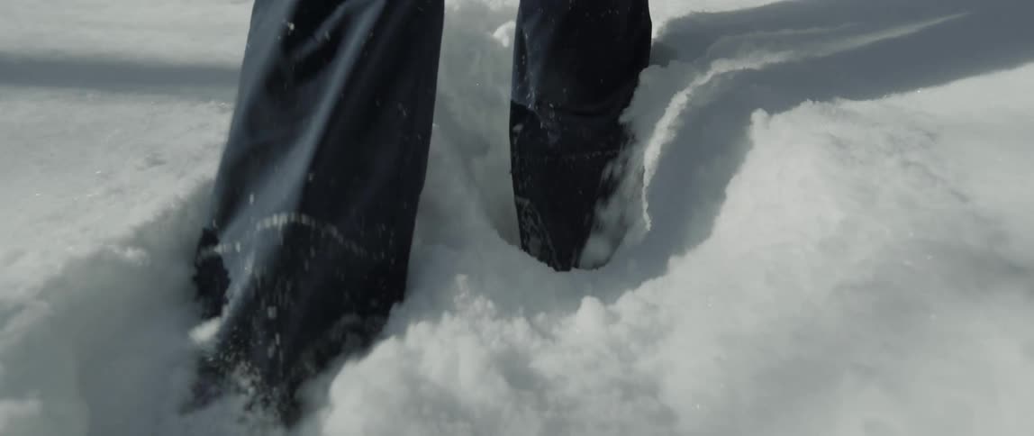Someone is walking in deep snow as they walk on a winter day