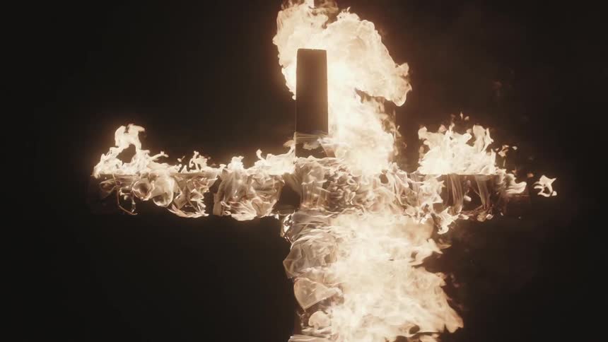 A cross made of wood is on fire