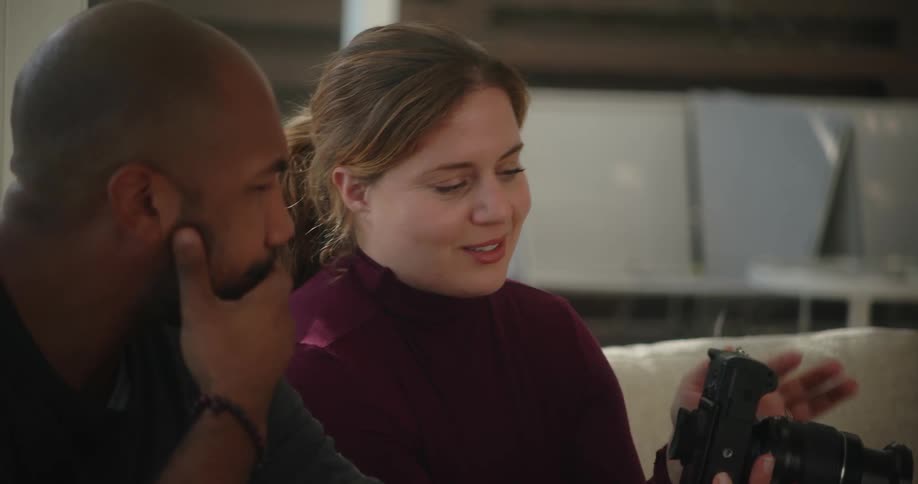 A man and woman talking in a room