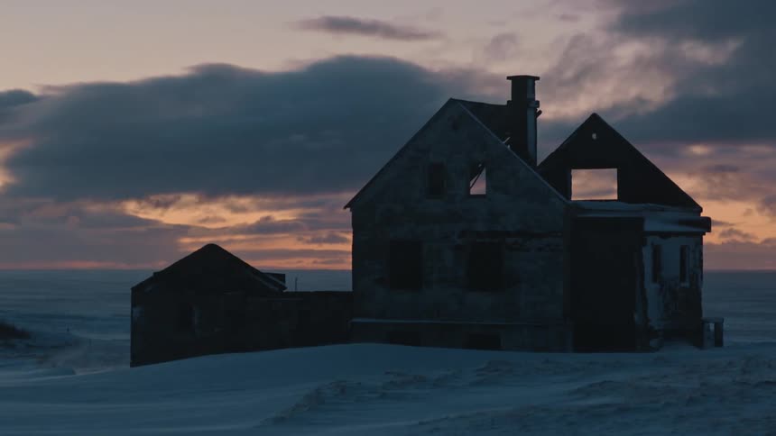 A house in the snow with rolling clouds