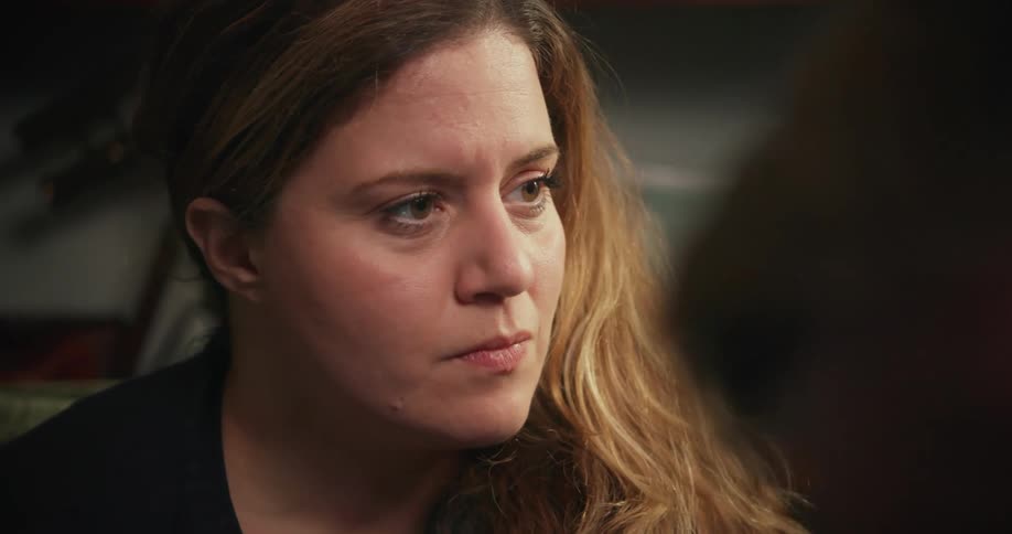 A woman pursing her lips while listening to a conversation