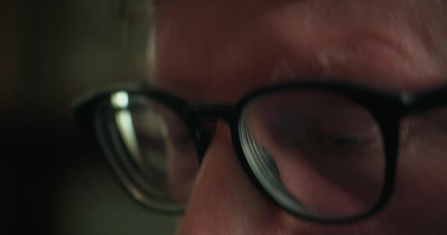 A man is wearing black glasses
