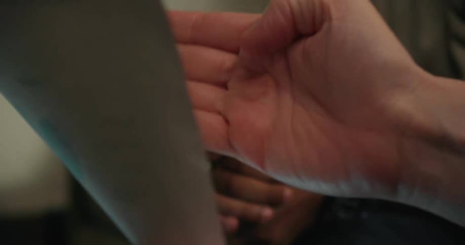 A couple using their hands to point at sheet of paper