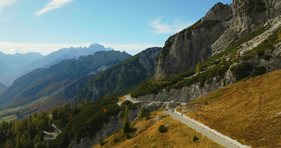 People riding bikes on a highway in the mountains