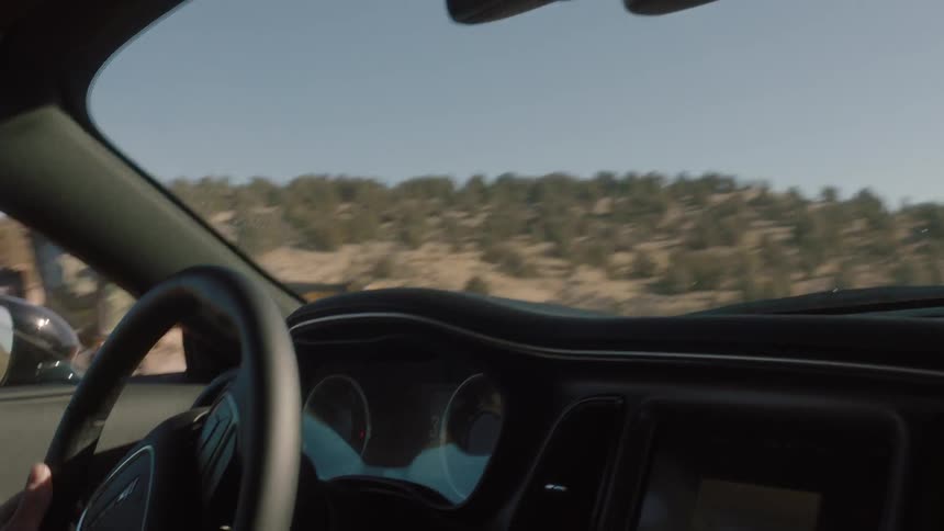 A person is driving fast outside on a field