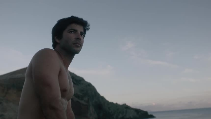 A man is outside looking over the water