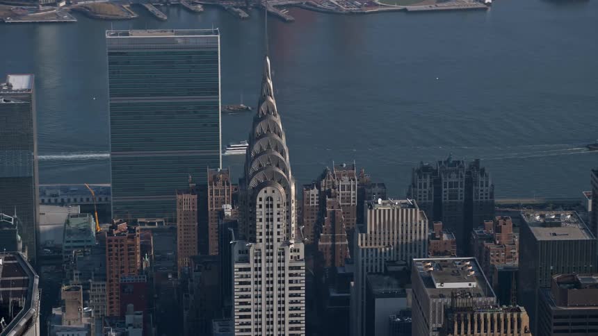 Aerial view of the iconic Chrysler Building in Midtown Manhattan New York City with the United Nations in the background during winter