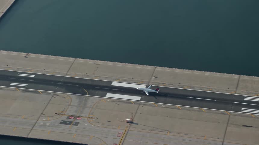 A commercial jet makes a graceful landing on the runway at LaGuardia Airport in Queens during winter