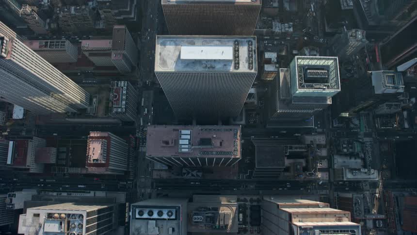 A stunning birds eye view of Midtown Manhattans high rise office buildings and city streets during a sunny winter day
